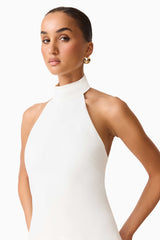 Brunette model wearing the Nolana Halter Midi Dress in White detail shot