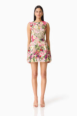 Brunette model wearing Flora Tulip Mini Dress in Pink & Green Floral front shot