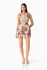 Brunette model wearing Flora Tulip Mini Dress in Pink & Green Floral posed shot