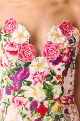 Brunette model wearing the Flora Strapless Gown in Pink & Green Floral detail shot