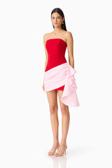 Brunette model wearing the June Strapless Mini in Red & Pink side shot