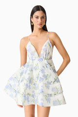 Brunette model wearing Cleo Tiered Mini Dress in White & Blue Floral close up shot