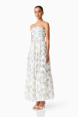 Brunette model wearing Cleo A-line Gown in White & Blue Floral side shot