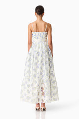 Brunette model wearing Cleo A-line Gown in White & Blue Floral back shot