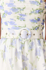 Brunette model wearing Cleo A-line Gown in White & Blue Floral detail shot