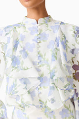 Brunette model wearing the Cleo Top & Skirt Set in White & Blue Floral detail shot