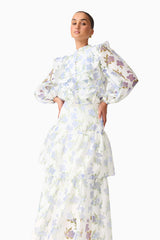 Brunette model wearing the Cleo Top & Skirt Set in White & Blue Floral close up posed shot