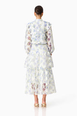 Brunette model wearing the Cleo Top & Skirt Set in White & Blue Floral back shot