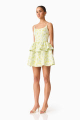 Brunette model wearing the Posey Jacquard Mini Dress in Green Floral side shot