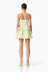 Brunette model wearing the Posey Jacquard Mini Dress in Green Floral back shot