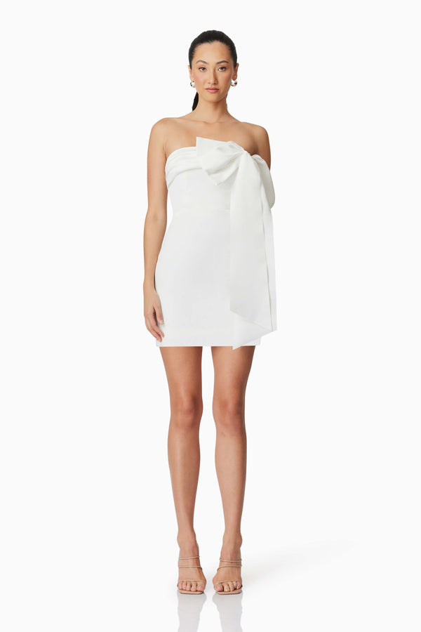 Brunette model wearing Marissa Bow Mini Dress in White front shot