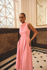 Brunette model wearing the Risa Cowl Neck Gown Dress in Bubblegum Pink campaign shot