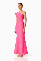 Brunette model wearing the Opline One Shoulder Gown in Hot Pink side shot
