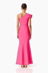 Brunette model wearing the Opline One Shoulder Gown in Hot Pink back shot