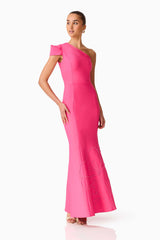 Brunette model wearing the Opline One Shoulder Gown in Hot Pink posed looking away shot