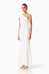Brunette model wearing the Opline One Shoulder Gown in White side shot 