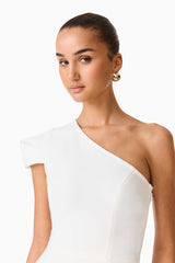 Brunette model wearing the Opline One Shoulder Gown in White close up shot 