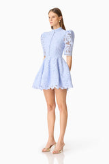 Brunette model wearing the Lacy puff sleeve mini dress in powder blue side shot