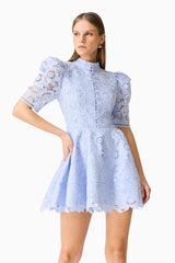 Brunette model wearing the Lacy puff sleeve mini dress in powder blue close  up shot