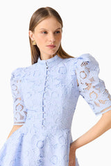 Brunette model wearing the Lacy puff sleeve mini dress in powder blue close up front shot