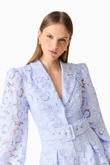 Brunette model wearing the Lacy Long Sleeve Playsuit in Powder Blue close up shot 