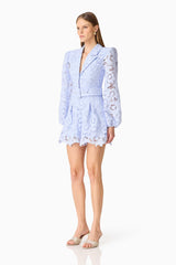 Brunette model wearing the Lacy Long Sleeve Playsuit in Powder Blue side shot 