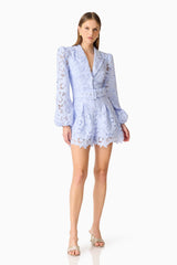 Brunette model wearing the Lacy Long Sleeve Playsuit in Powder Blue posed shot 