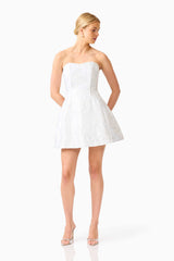 Blonde model wearing the Floralie Strapless Mini Dress in Silver posed shot