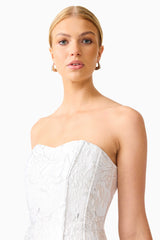 Blonde model wearing the Floralie Strapless Mini Dress in Silver close up shot