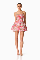 Brunette model wearing the Floralie Strapless Mini Dress in Pink Floral posed front shot 
