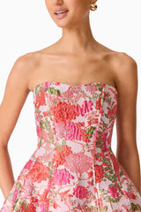 Brunette model wearing the Floralie Strapless Mini Dress in Pink Floral detail shot 