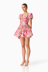 Brunette model wearing the Floralie Short Sleeve Mini Dress in Pink Floral side shot 