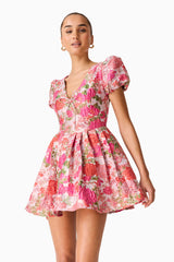 Brunette model wearing the Floralie Short Sleeve Mini Dress in Pink Floral posed close up shot 