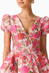 Brunette model wearing the Floralie Short Sleeve Mini Dress in Pink Floral detail shot 