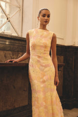 Brunette model wearing the Zaria Sleevless Gown in Yellow Floral campaign shot