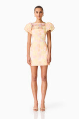 Brunette model wearing theZaria Puff Sleeve Mini Dress in Yellow Floral front shot