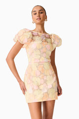 Brunette model wearing theZaria Puff Sleeve Mini Dress in Yellow Floral posed close up shot