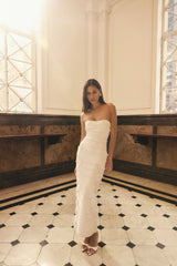 Brunette model wearing the Lucine Strapless Gown Dress in White campaign shot 