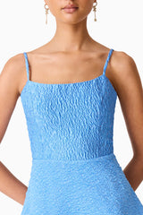 Brunette model wearing the Briallen Jacquard Gown in Blue Detail Shot