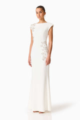 Brunette model wearing the Veda Embellished Gown in White Side Shot