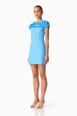 Brunette model wearing the Dali Floral Applique Mini Dress in Blue Side Shot