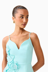 Brunette model wearing the Stella Tulip Mini Dress in Aqua Blue side close up shot 
