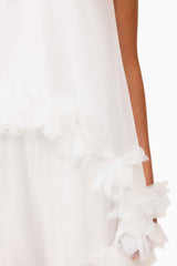 Brunette model wearing the Poppy Cape Gown in White detail shot 