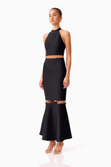 Brunette model wearing the Naomi Halter Gown in Black side shot 