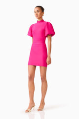 Brunette model wearing the Naomi Puff Sleeve Mini Dress in Raspberry Pink waking shot 