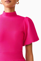 Brunette model wearing the Naomi Puff Sleeve Mini Dress in Raspberry Pink detail shot