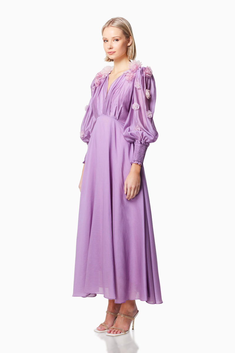 Blonde model wearing NECTAR 3D ROSETTE MAXI DRESS IN PURPLE side shot