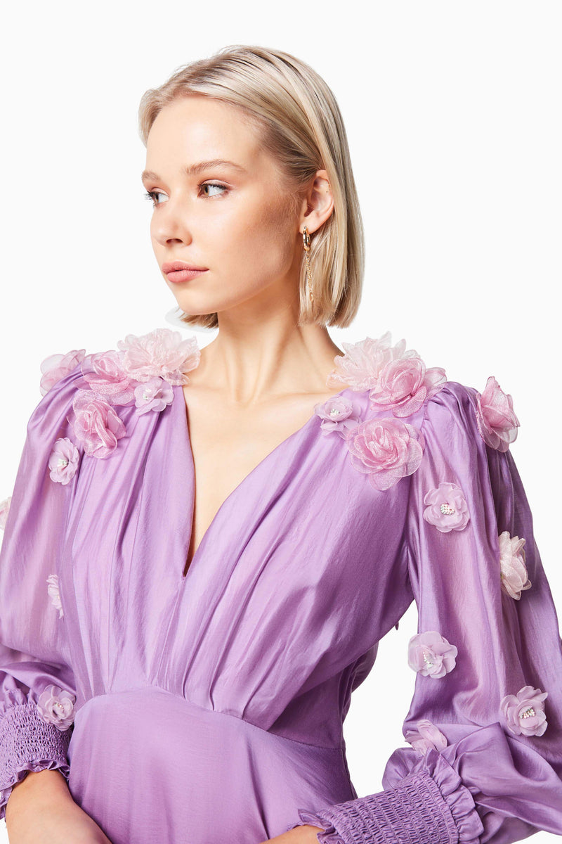 Blonde model wearing NECTAR 3D ROSETTE MAXI DRESS IN PURPLE close up shot