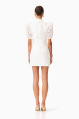Brunette model wearing the Elowen Floral Applique Mini Dress in White back shot