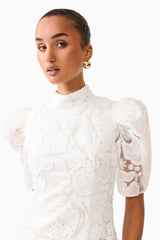 Brunette model wearing the Elowen Floral Applique Mini Dress in White close up shot